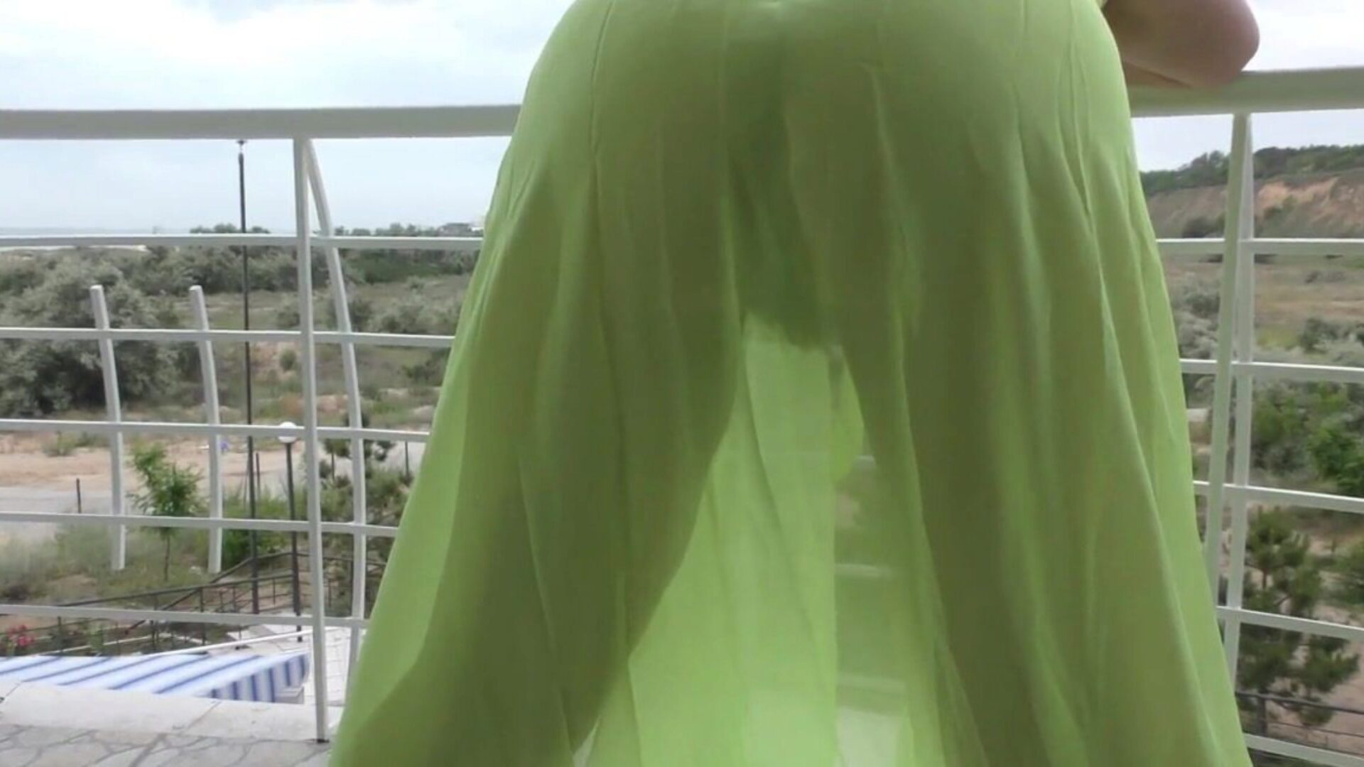 Hairy aged displaying on balcony Hairy older in see-through suit on balcony